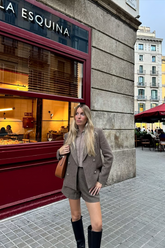 a lady wears a camel wool blazer with matching shorts